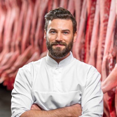 portrait of a handsome butcher at the manufacturing e1674720981249